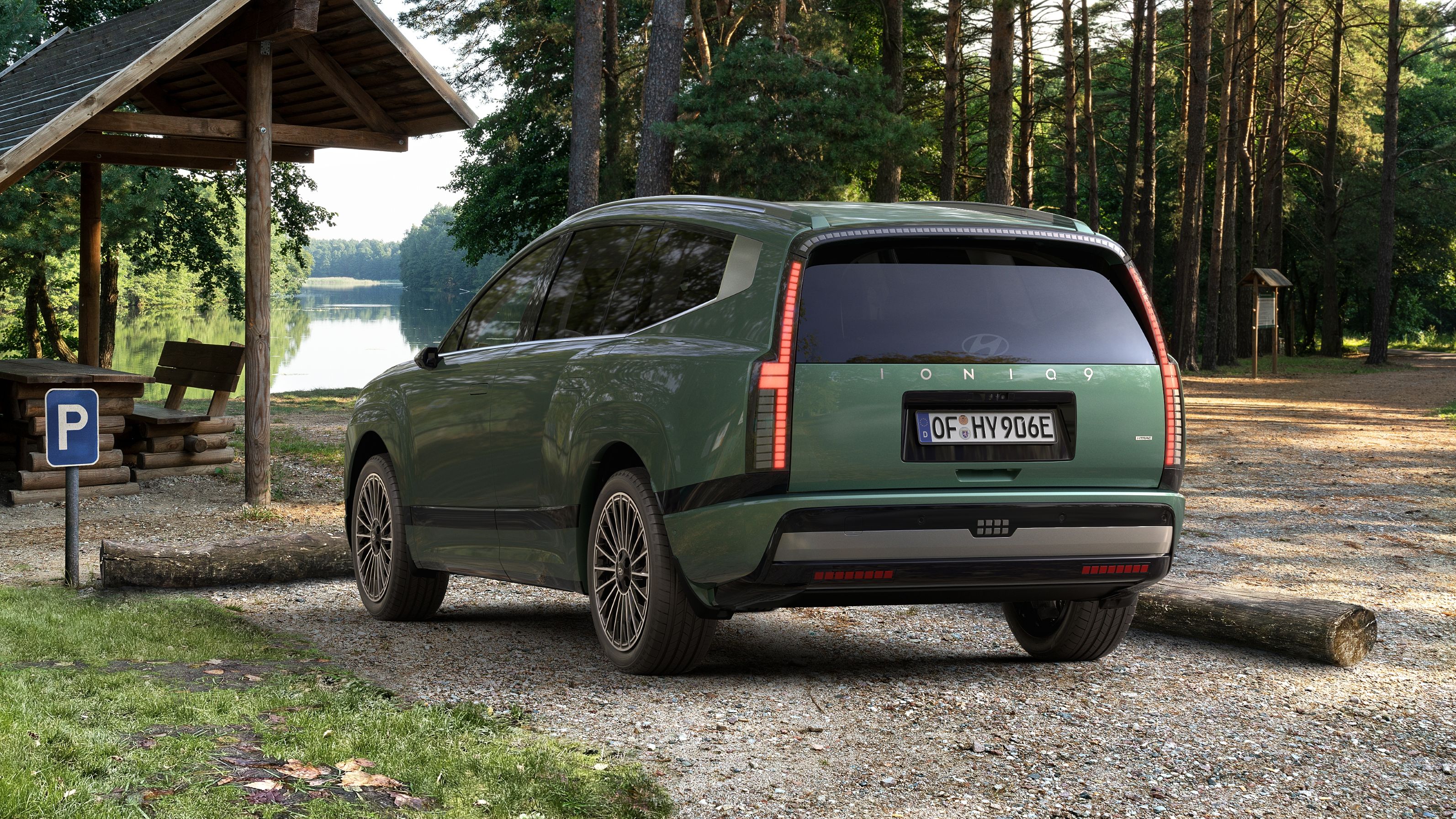 Rear view of the Hyundai IONIQ 9 electric SUV parked at a campsite.